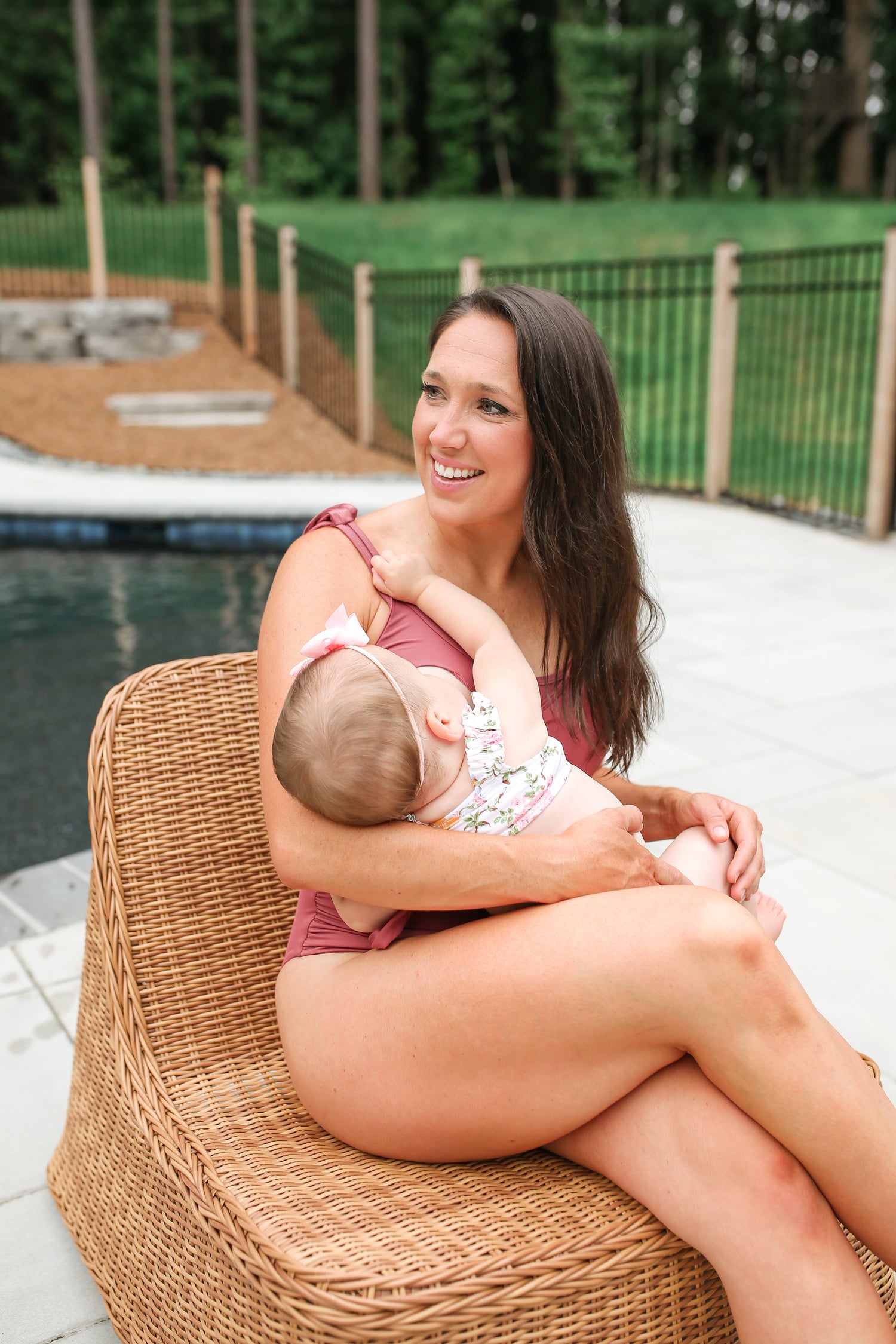nursing mother shown breastfeeding her baby in a mauve tie shoulder one piece nursing swimsuit 